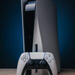 PlayStation 5 console beside physical game discs.
