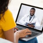 Doctor conducting a virtual healthcare consultation with a patient in Nigeria.