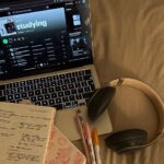 Student using headphones while studying at a desk