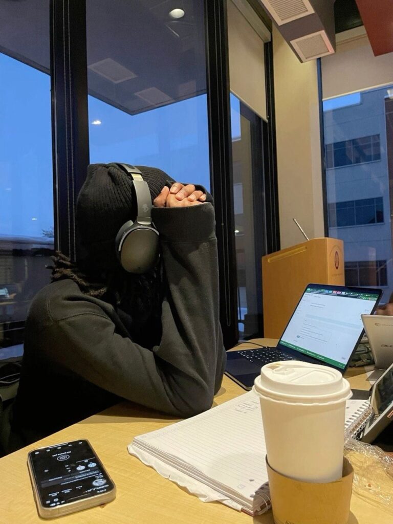 Student listening to an online lecture with headphones