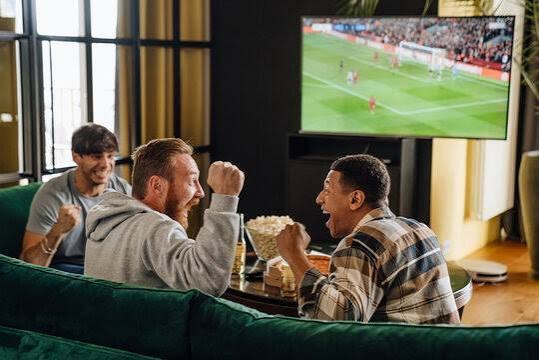 Football fans watching a live match on television as DStv and GOtv expand sports coverage